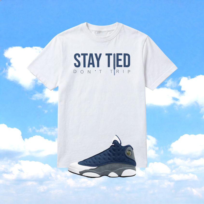 Front view of sand graphic t-shirt designed to match Flint 13s sneakers, bold French blue and flint grey Stay Tied print by Sneaker Tied Apparel